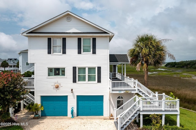 coastal home with a garage and a porch