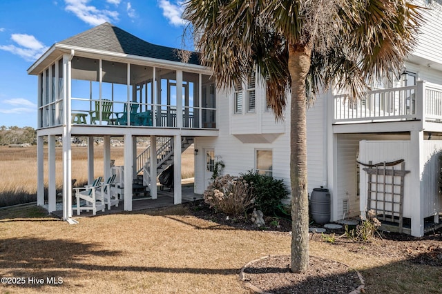 rear view of property featuring a sunroom