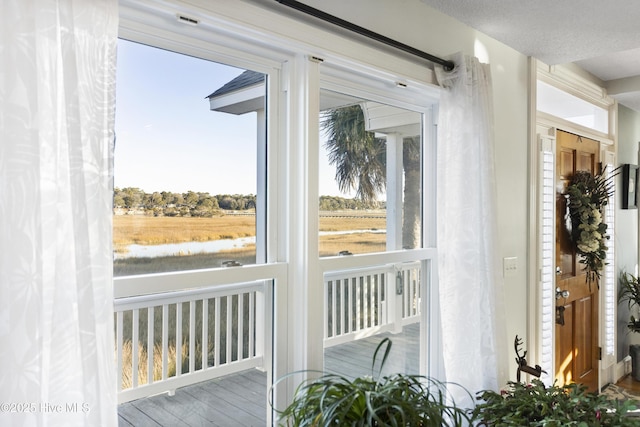 doorway featuring a rural view and hardwood / wood-style flooring