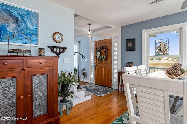 entryway with wood-type flooring and a textured ceiling