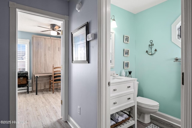 bathroom featuring toilet, hardwood / wood-style floors, ceiling fan, a textured ceiling, and vanity