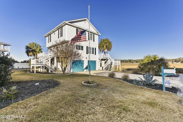 view of front of home with a front yard and a garage