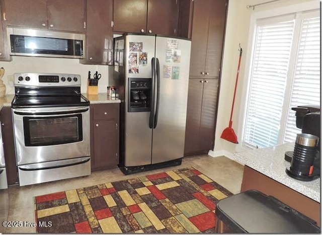 kitchen featuring a healthy amount of sunlight, dark brown cabinets, and appliances with stainless steel finishes