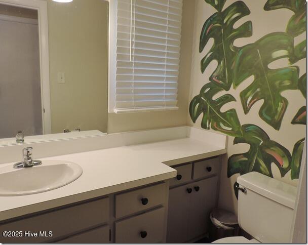 bathroom featuring toilet and vanity