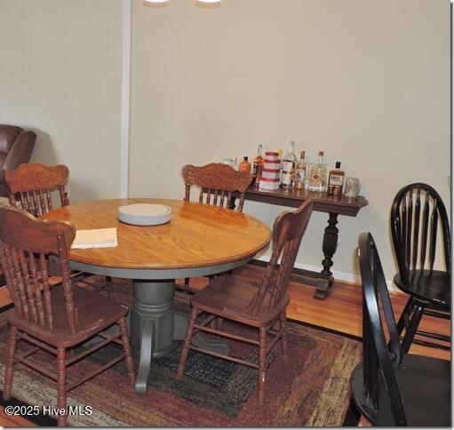 dining area with hardwood / wood-style floors