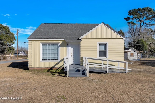 back of property featuring a yard