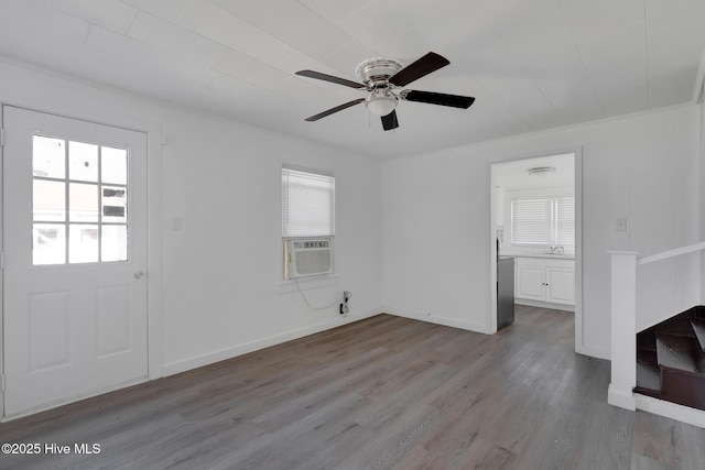 interior space featuring ceiling fan, light wood-type flooring, and cooling unit