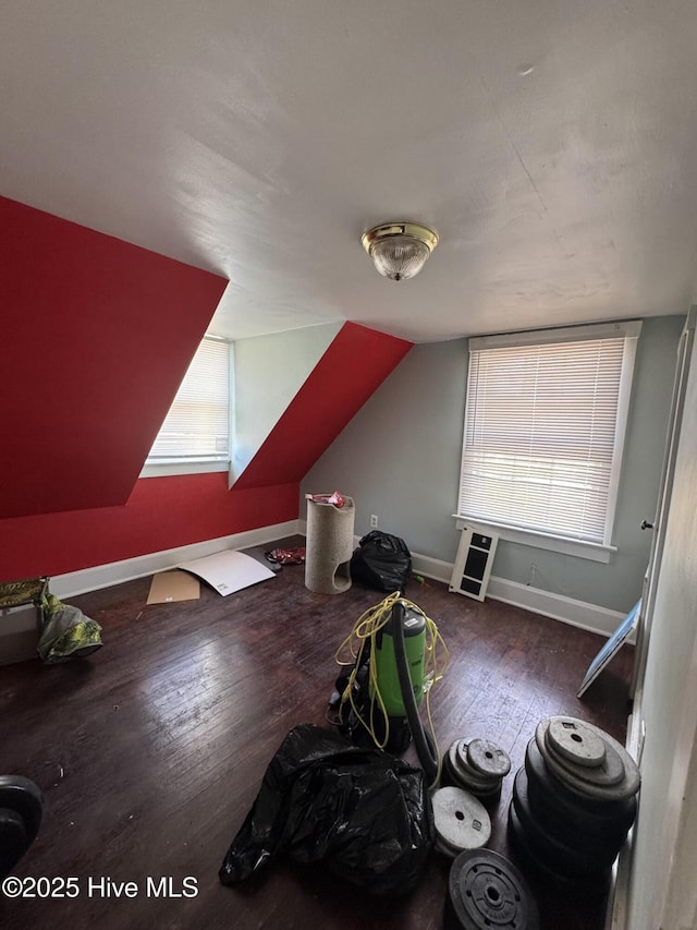 bonus room with lofted ceiling and hardwood / wood-style floors