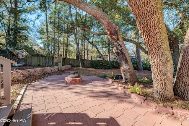 view of patio / terrace featuring an outdoor fire pit