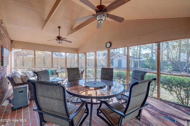 sunroom featuring vaulted ceiling and ceiling fan