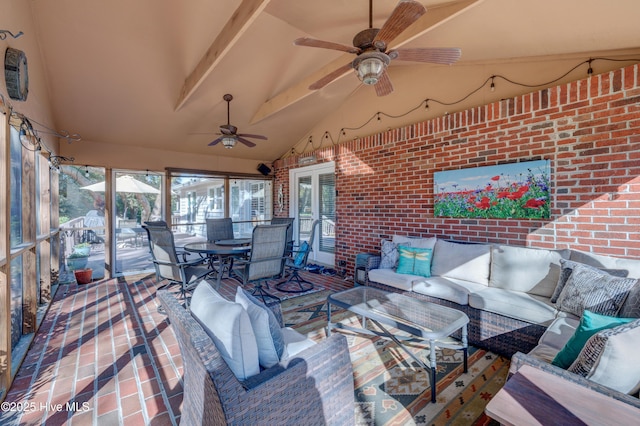 sunroom featuring vaulted ceiling and ceiling fan