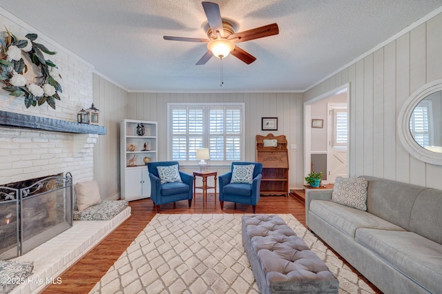 living room with ornamental molding, wood-type flooring, and a wealth of natural light