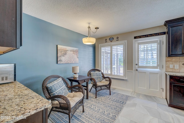 sitting room with a textured ceiling