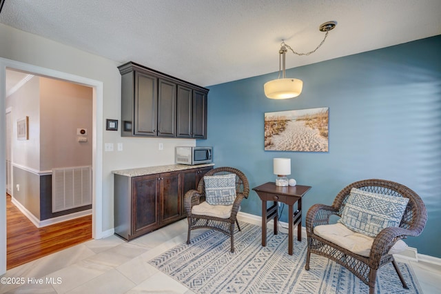 living area with a textured ceiling