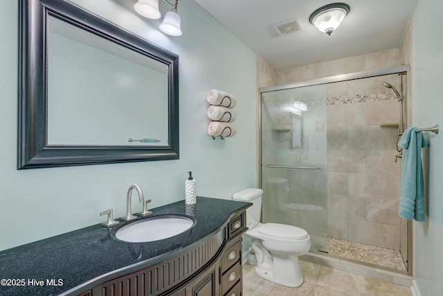 bathroom with an enclosed shower, vanity, tile patterned flooring, and toilet