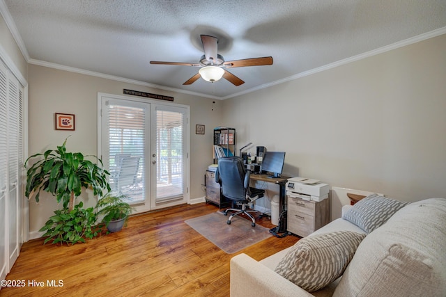 office space with french doors, ornamental molding, ceiling fan, a textured ceiling, and light hardwood / wood-style flooring