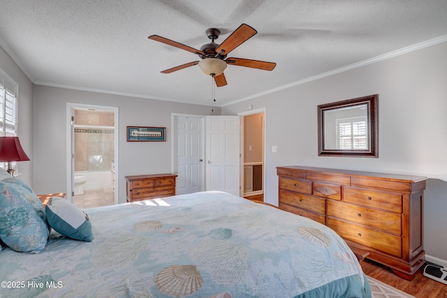 bedroom with connected bathroom, crown molding, wood-type flooring, and a textured ceiling