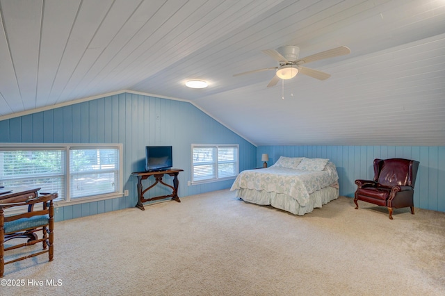 bedroom with ceiling fan, vaulted ceiling, and carpet