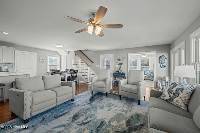 living room with ceiling fan and hardwood / wood-style flooring