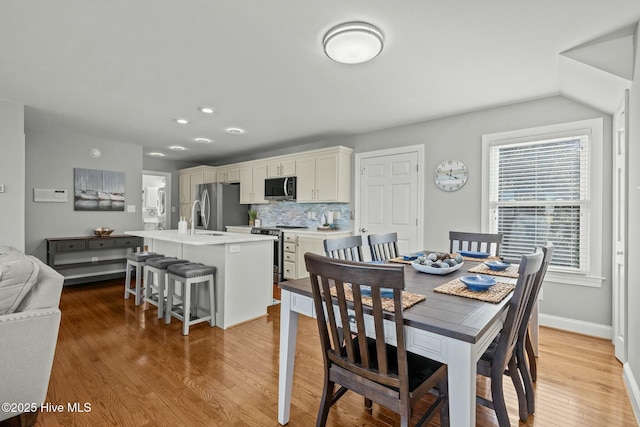 dining space featuring wood-type flooring