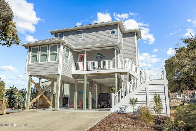 rear view of house with covered porch and a carport