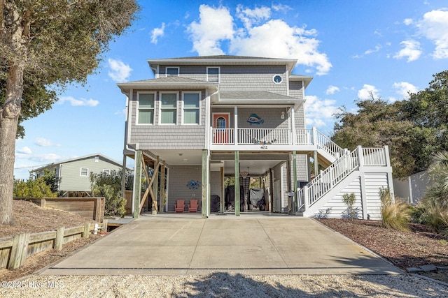 rear view of house featuring a porch and a carport