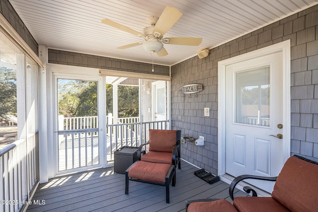 sunroom featuring ceiling fan