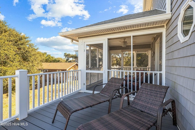 deck featuring ceiling fan and a sunroom