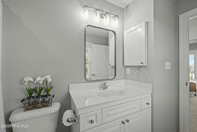 bathroom featuring toilet and vanity