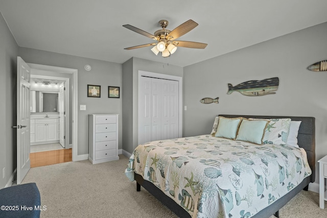 bedroom with ceiling fan, light colored carpet, and a closet