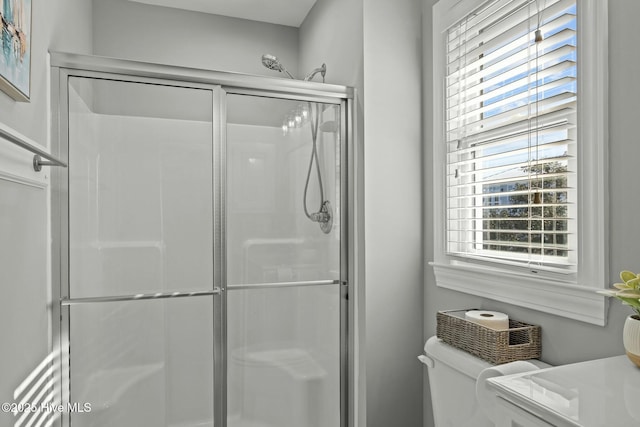 bathroom featuring toilet and walk in shower