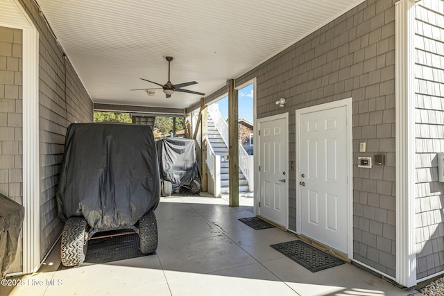 exterior space featuring ceiling fan and concrete floors