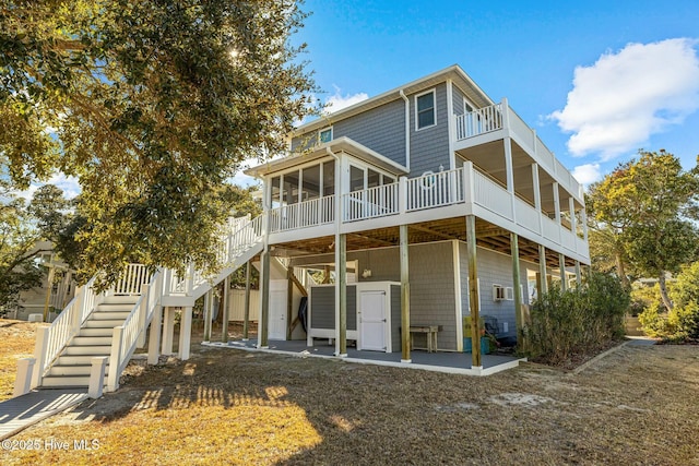 rear view of house with a patio and a sunroom