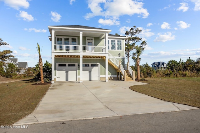 coastal home with a front yard, covered porch, and a garage