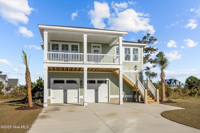 beach home featuring covered porch and a garage