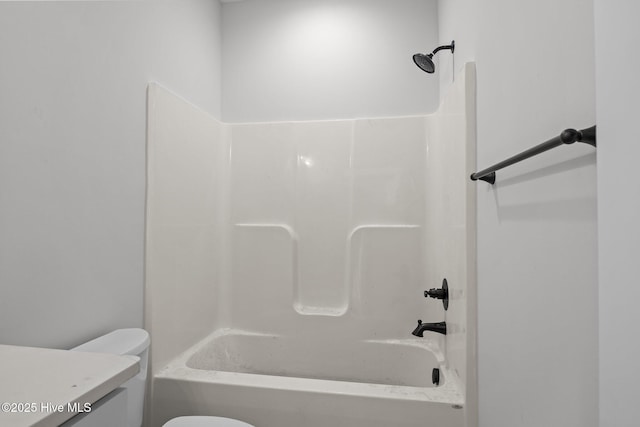 full bathroom featuring toilet, vanity, and washtub / shower combination