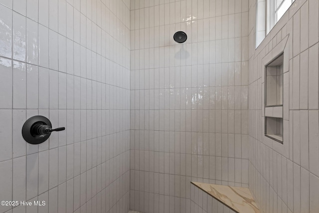 bathroom with a tile shower