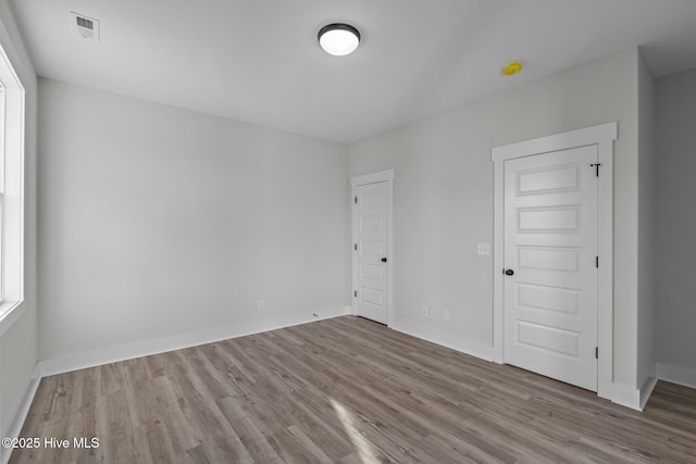 empty room with light hardwood / wood-style floors