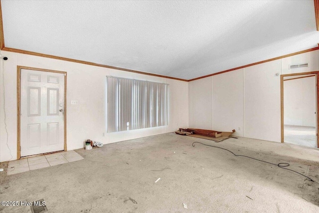 interior space with a textured ceiling and crown molding