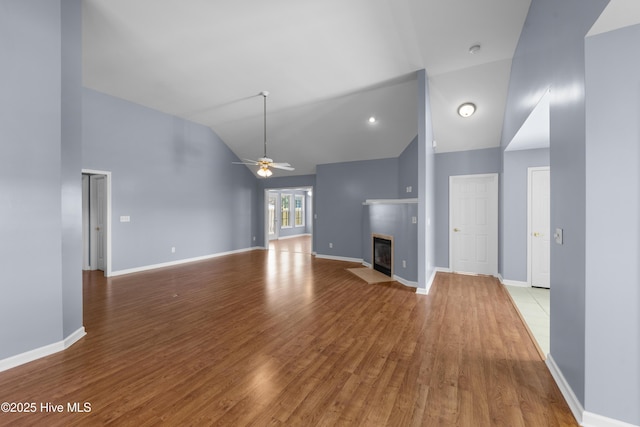 unfurnished living room featuring light hardwood / wood-style flooring, high vaulted ceiling, and ceiling fan