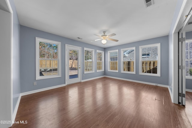 unfurnished sunroom featuring ceiling fan