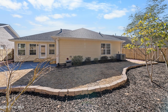 rear view of house featuring cooling unit