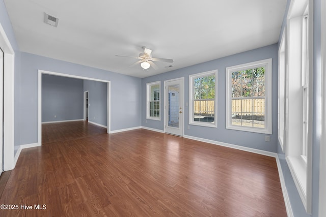 interior space featuring dark wood-type flooring and ceiling fan