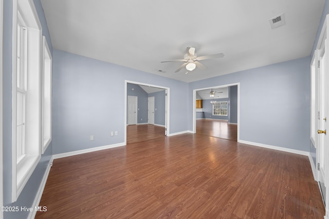 unfurnished room featuring ceiling fan and dark hardwood / wood-style flooring