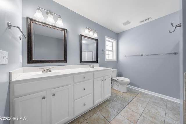 bathroom with tile patterned flooring, vanity, and toilet