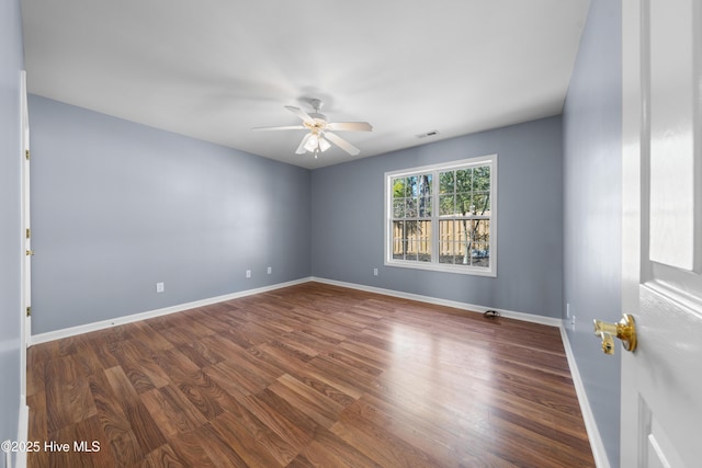 spare room with hardwood / wood-style flooring and ceiling fan