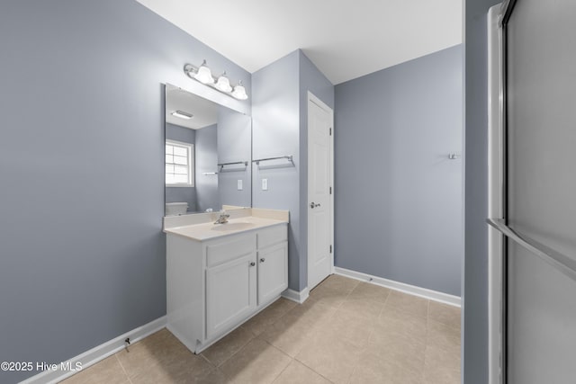 bathroom featuring vanity, toilet, and tile patterned flooring