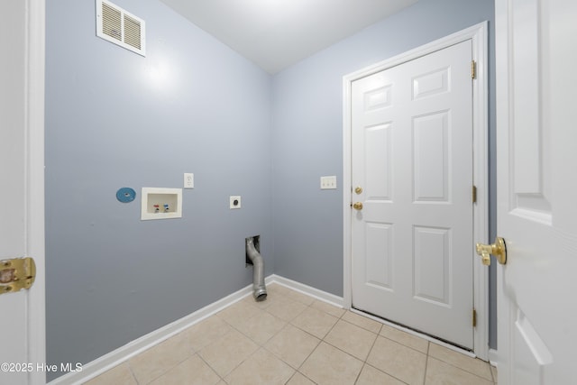 laundry area featuring electric dryer hookup, washer hookup, and light tile patterned floors