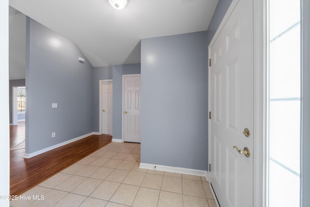 foyer entrance featuring lofted ceiling and light tile patterned floors