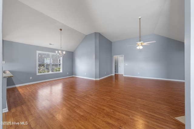 unfurnished living room featuring wood-type flooring, vaulted ceiling, and ceiling fan with notable chandelier